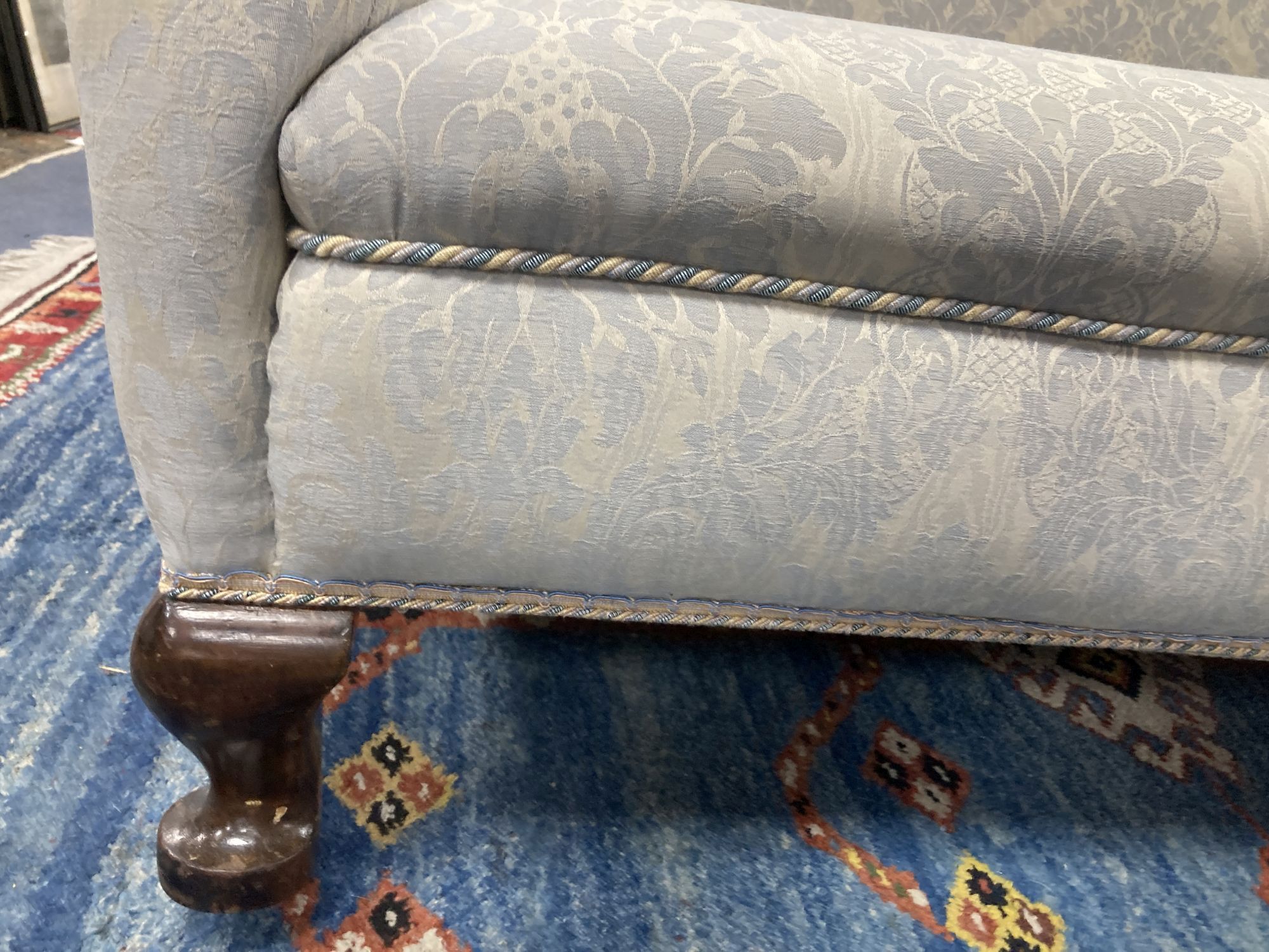 An early 20th century Queen Anne style upholstered wing back settee, length 140cm, depth 75cm, height 112cm